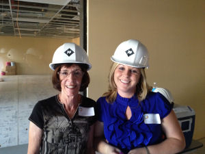 Principal and Assistant Principal wear white hard hars while touring school