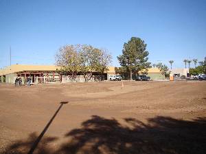 Expanse of smooth dirt playground outside elementary school building